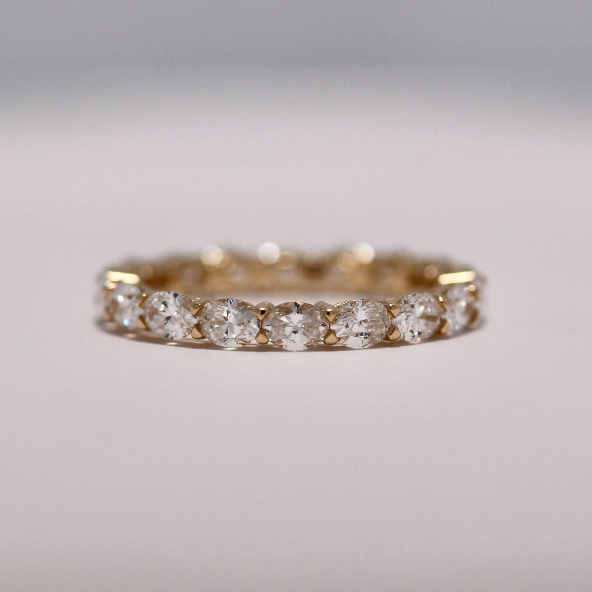 Oval cut diamond wedding band
